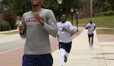 In this Sept. 28, 2016 photo, Connecticut&#39;s Terry Larrier, left, crosses the finish line during the Husky Run on the campus of the University of Connecticut, in Storrs, Conn. UConn coach Kevin Ollie is hoping his young Huskies can gel early and peak late. The American Athletic Conference tournament champions have added a highly touted recruiting class of five freshmen and VCU transfer Terry Larrier to a solid core returning from last year’s 25-11 squad. (Jared Ramsdell/Journal Inquirer via AP)