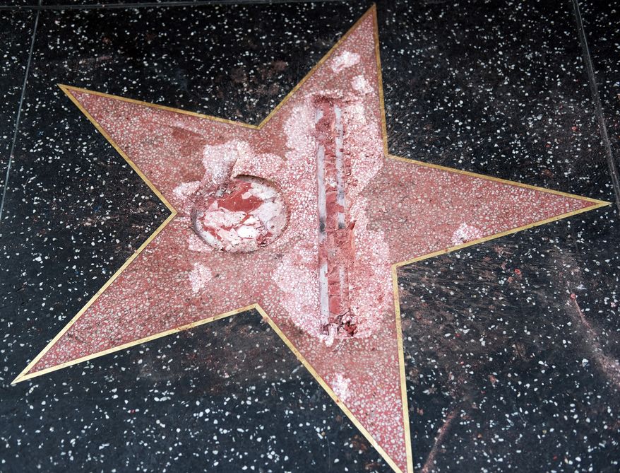 The vandalized star for Republican presidential candidate Donald Trump is seen on the Hollywood Walk of Fame, Wednesday, Oct. 26, 2016, in Los Angeles. Detective Meghan Aguilar said investigators were called to the scene before dawn Wednesday following reports that Trump's star was destroyed by blows from a hammer. (AP Photo/Richard Vogel)