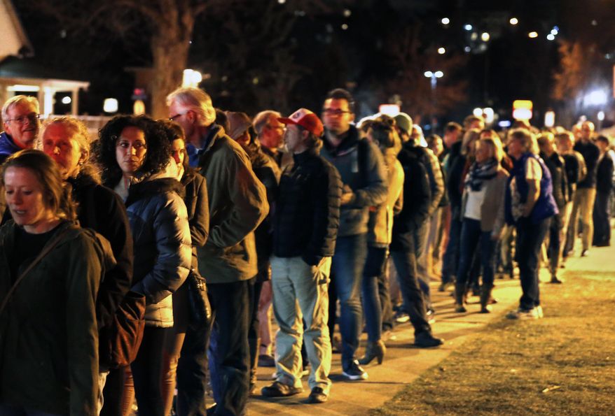 FILE - In this March 1, 2016 file photo, voters wait in line for hours to participate in the Colorado Democratic caucus, in Boulder, Colo. Colorado will vote on two measures that would reinstate a presidential primary and allow unaffiliated voters to participate in major party primaries. The measures grew out of frustration with this year's caucuses in which Republicans didn't vote for president and Democrats struggled to accommodate an unprecedented turnout. (AP Photo/Brennan Linsley, file)