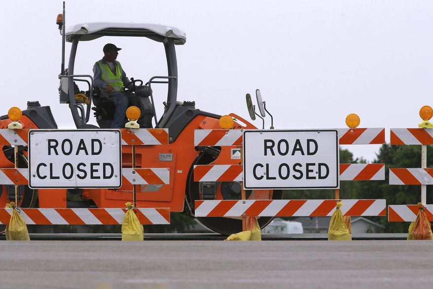 FILE - In this June 22, 2016 photo, road construction crews work to build a four lane highway on Route 29 in Edinburg, Ill. The first question on Illinois ballots on Nov. 8 election isn't for president, senator or comptroller, but a constitutional amendment geared toward preventing transportation-related funding from being used elsewhere. Backers include unions and the construction industry. (AP Photo/Seth Perlman File)