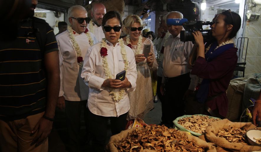 Cristeta Comerford, Chef to the President of the United States of America, third left, and other Chefs of several heads of states, visit Khari Baoli, Asia's largest spice market, in New Delhi, India, Tuesday, Oct. 25, 2016. Several chefs of Heads of States are visiting India for the Annual General Assembly of 'Le Club des Chefs des Chefs' (CCC), touted to be world's most exclusive gastronomic society, which aims to use food as a bridge between cultures and societies. (AP Photo/Altaf Qadri)