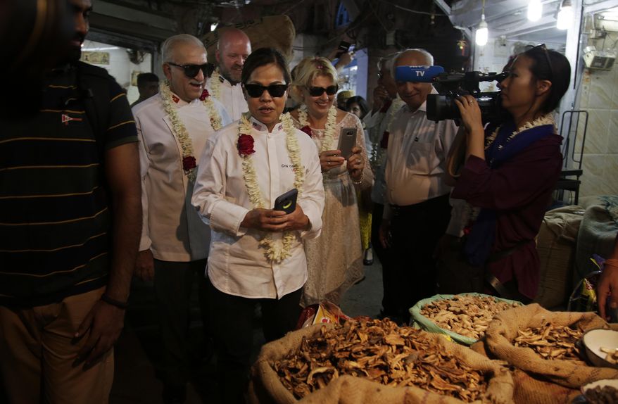 Cristeta Comerford, Chef to the President of the United States of America, third left, and other Chefs of several heads of states, visit Khari Baoli, Asia's largest spice market, in New Delhi, India, Tuesday, Oct. 25, 2016. Several chefs of Heads of States are visiting India for the Annual General Assembly of 'Le Club des Chefs des Chefs' (CCC), touted to be world's most exclusive gastronomic society, which aims to use food as a bridge between cultures and societies. (AP Photo/Altaf Qadri)