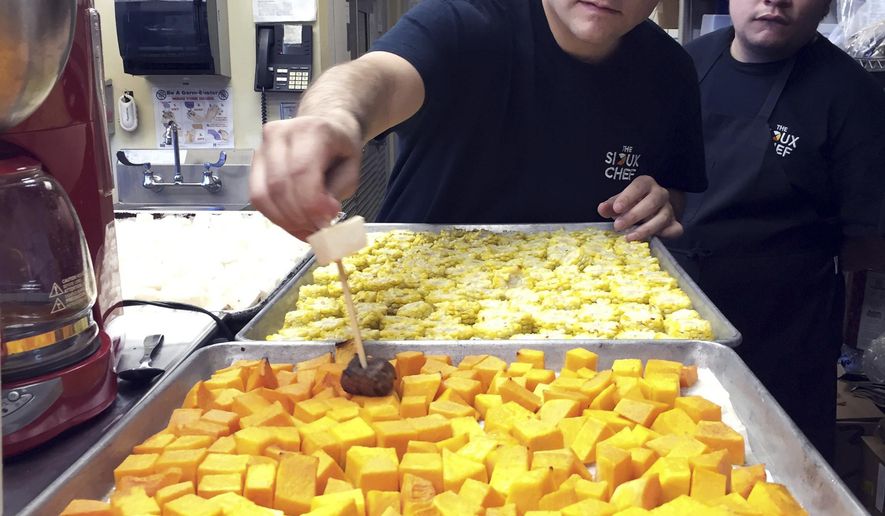 In this Oct. 24, 2016 photo, Sean Sherman shows one of his chefs how to skewer vegetables for an upcoming dinner for donors in Minneapolis. Sherman, an Oglala Lakota chef, embarked on a journey almost a decade ago to bring Native American cuisine to more tables. Thanks to the help of donors, he's now preparing to open his own restaurant in the Minneapolis area, with a focus on getting back to sustainable, organic foods from the region which Native Americans hunted and gathered before unhealthy processed foods were introduced to their diet. (AP Photo/Amy Forliti)