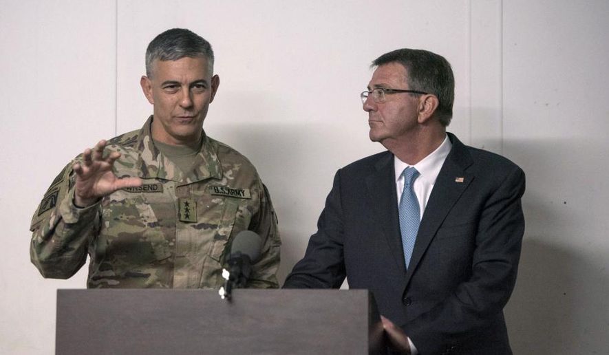 In this photo provided by the Defense Department, taken Oct. 23, 2016, Defense Secretary Ash Carter listens as U.S. Army Lt. Gen. Stephen Townsend, commander of Combined Joint Task Force-Operation Inherent Resolve, speaks during a news conference in Erbil, Iraq. Townsend, the commander of the U.S.-led coalition against the Islamic State group says there’s an urgent need to encircle the extremists’ stronghold in the Syrian city of Raqqa because of intelligence warnings that attacks on Western targets are being plotted there. (U.S. Air Force Tech. Sgt. Brigitte N. Brantley/DoD via AP)