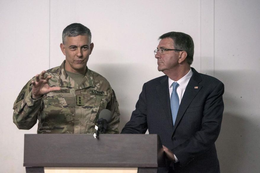 In this photo provided by the Defense Department, taken Oct. 23, 2016, Defense Secretary Ash Carter listens as U.S. Army Lt. Gen. Stephen Townsend, commander of Combined Joint Task Force-Operation Inherent Resolve, speaks during a news conference in Erbil, Iraq. Townsend, the commander of the U.S.-led coalition against the Islamic State group says there’s an urgent need to encircle the extremists’ stronghold in the Syrian city of Raqqa because of intelligence warnings that attacks on Western targets are being plotted there. (U.S. Air Force Tech. Sgt. Brigitte N. Brantley/DoD via AP)