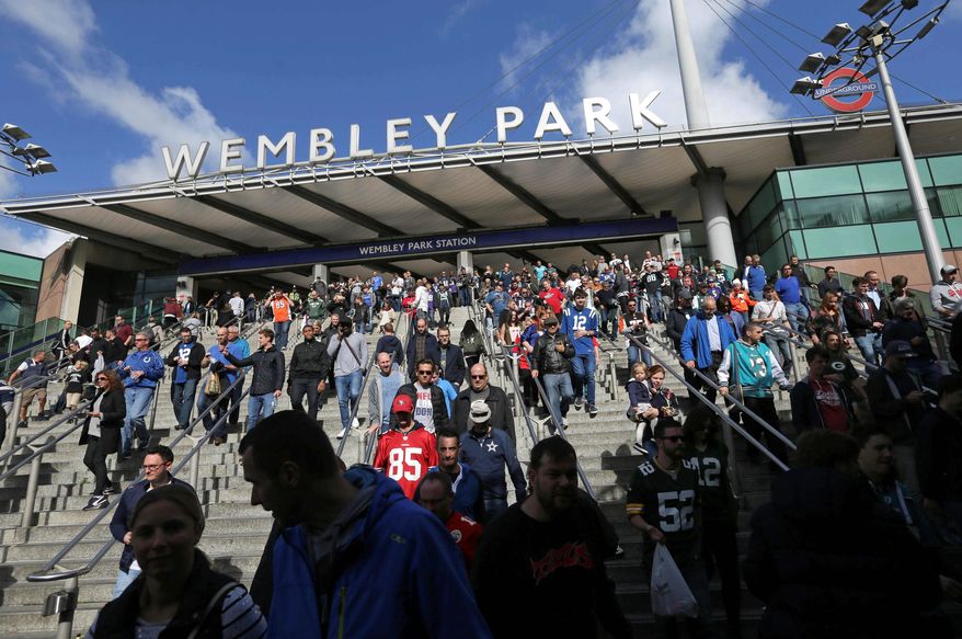 Supporters leave Wembley Park tube station in London as they make their way to the NFL game between the Indianapolis Colts and Jacksonville Jaguars at Wembley Stadium on Oct. 2. (Associated Press)