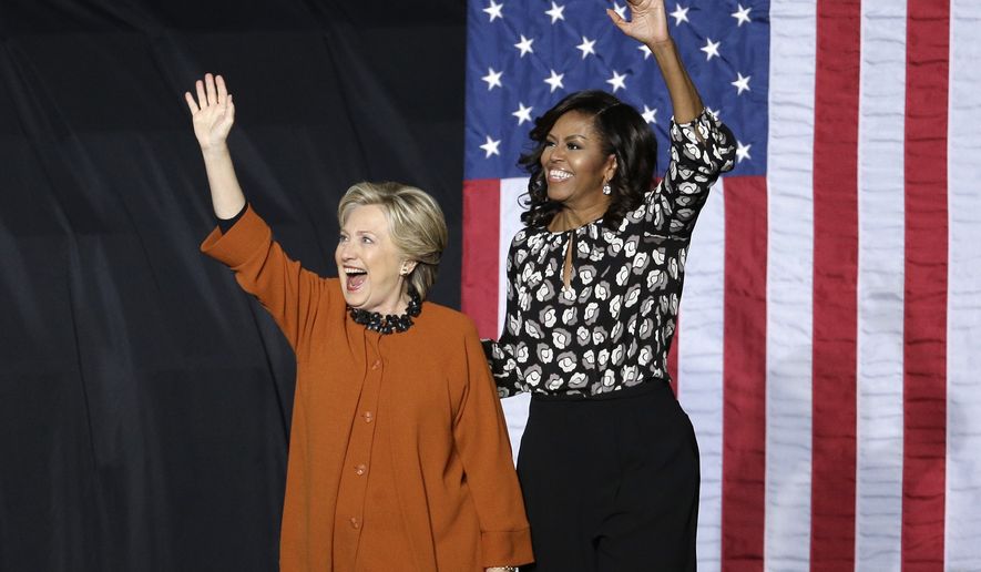 Democratic presidential candidate Hillary Clinton and first lady Michelle Obama wave to supporters during a campaign rally in Winston-Salem, N.C., Thursday, Oct. 27, 2016. (AP Photo/Chuck Burton)