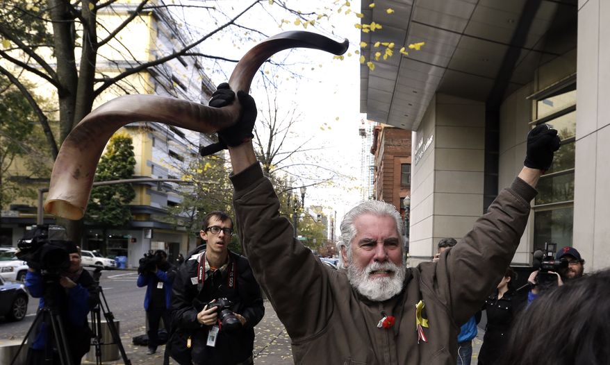 Brand Thornton celebrates after hearing a verdict outside federal court in Portland, Ore., Thursday, Oct. 27, 2016. A jury exonerated brothers Ammon and Ryan Bundy and five others of conspiring to impede federal workers from their jobs at the Malheur National Wildlife Refuge. (AP Photo/Don Ryan)