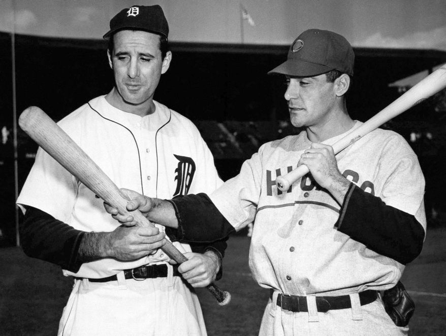 FILE - In this Oct. 4, 1945, file photo, Detroit Tigers leftfielder Hank Greenberg, left, and Chicago Cubs first baseman Phil Cavaretta, right, talk before Game 2 of baseball's World Series in Detroit. (AP Photo/File)