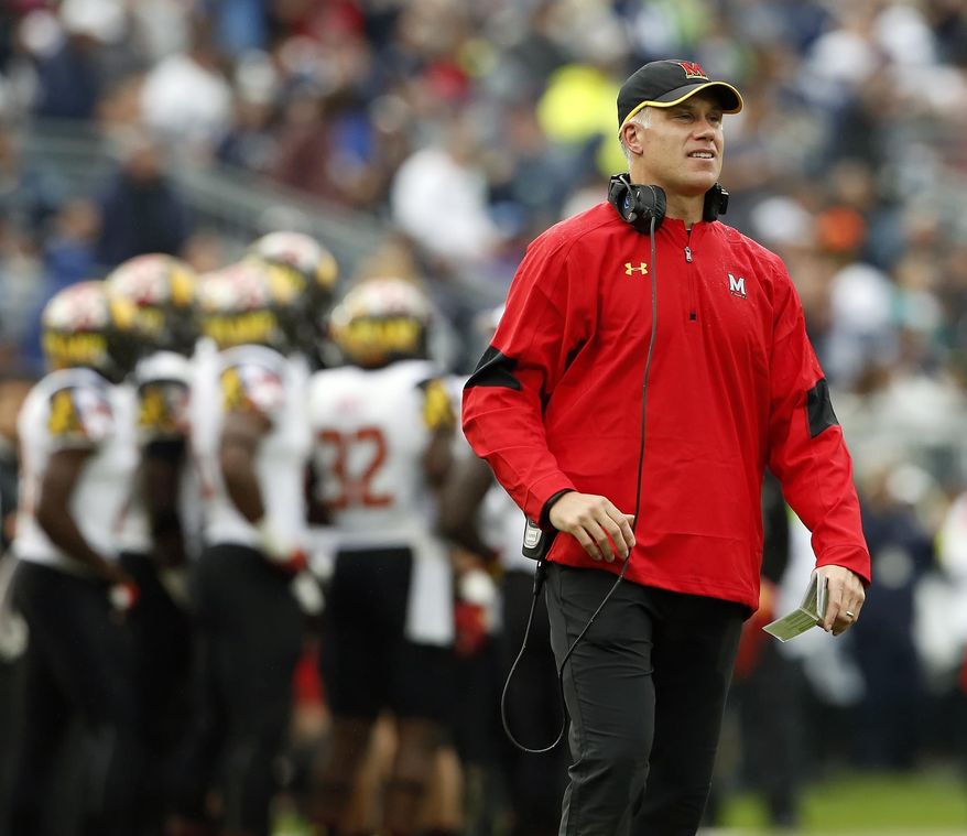 FILE - In this Oct. 8, 2016, file photo, Maryland head coach DJ Durkin watches from the sidelines against Penn State during the second half of an NCAA college football game in State College, Pa. After going 3-9 last season and winning only one Big Ten game, Maryland now needs only one victory to become bowl eligible. (AP Photo/Chris Knight, File)