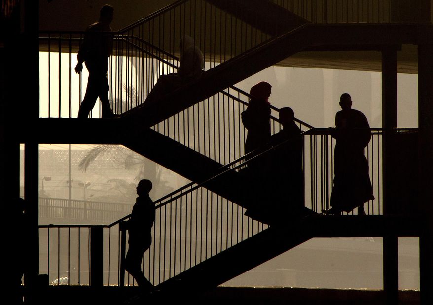 Egyptians walk down the stairs of a bridge in Cairo, Egypt, Thursday, Oct. 27, 2016. Egypt is suffering an acute foreign currency shortage because of the decimation of its lucrative tourism industry, a fall in Suez Canal revenues and reduced remittances from Egyptian expatriates. It also suffers from double digit rates of inflation and unemployment. (AP Photo/Amr Nabil)