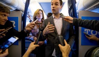 Campaign Manager Robby Mook, right, accompanied by Director of Communications Jennifer Palmieri, left, speaks to members of the media aboard Democratic presidential candidate Hillary Clinton&#39;s campaign plane, Friday, Oct. 28, 2016, while traveling to Iowa. (AP Photo/Andrew Harnik)