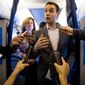 Campaign Manager Robby Mook, right, accompanied by Director of Communications Jennifer Palmieri, left, speaks to members of the media aboard Democratic presidential candidate Hillary Clinton&#39;s campaign plane, Friday, Oct. 28, 2016, while traveling to Iowa. (AP Photo/Andrew Harnik)