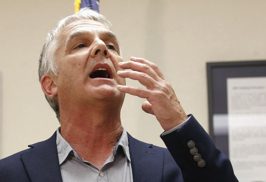 FILE - In this July 23, 2014, file photo, Arizona Republic justice reporter Michael Kiefer describes what he saw as a witness to the execution of Joseph Rudolph Wood, at the state prison in Florence, Ariz. One of two lawsuits against the state of Arizona over the secrecy around executions will get its day in court on Friday, Oct. 28, 2016, as attorneys present oral arguments. The lawsuit was filed by a coalition of news organizations including The Associated Press after the July 2014 execution of Wood, who died nearly two hours after he was injected with a two-drug combination. (AP Photo, File)