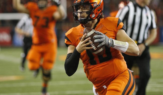 FILE - In this Oct. 8, 2016, file photo, Oregon State quarterback Darell Garretson runs into the end zone with the winning touchdown in overtime in an NCAA college football game against California, in Corvallis, Ore. Oregon State hosts Washington State on Saturday. (AP Photo/Timothy J. Gonzalez, File)