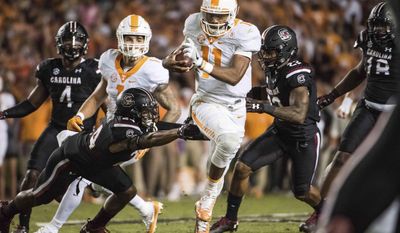 Tennessee quarterback Joshua Dobbs (11) runs the ball against South Carolina defensive back D.J. Smith (24) during the first half of an NCAA college football game Saturday, Oct. 29, 2016, in Columbia, S.C. (AP Photo/Sean Rayford)