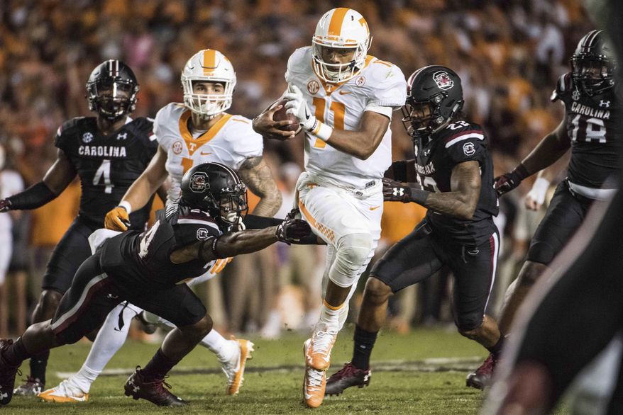 Tennessee quarterback Joshua Dobbs (11) runs the ball against South Carolina defensive back D.J. Smith (24) during the first half of an NCAA college football game Saturday, Oct. 29, 2016, in Columbia, S.C. (AP Photo/Sean Rayford)