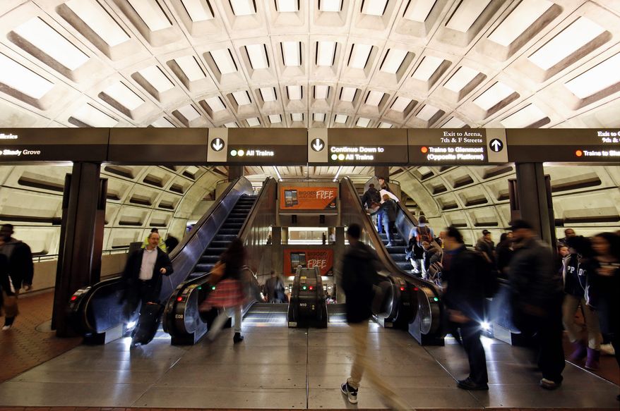Metro riders use the escalators in the Gallery Place-Chinatown Metro station in Washington on Tuesday, March 15, 2016. (Associated Press) **FILE**