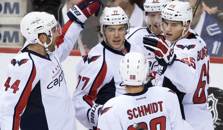 Washington Capitals&#39; Brooks Orpik, T.J. Oshie, Nate Schmidt, Lars Eller and Andre Burakovsky, from left, celebrate Oshie&#39;s goal against the Vancouver Canucks during the third period of an NHL hockey game Saturday, Oct. 29, 2016, in Vancouver, British Columbia. (Darryl Dyck/The Canadian Press via AP)