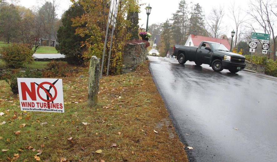 In this Tuesday, Oct. 18, 2016 photo, a yard sign opposing an industrial wind project sits at the side of the road in Grafton, Vt. Voters in Grafton and Windham are going to cast ballots Nov. 8 on whether to go forward with a plan for 24 turbines in the two communities. Developer Iberdrola Renewables is offering residents of the two towns direct payments if the project is built. (AP Photo/Wilson Ring)