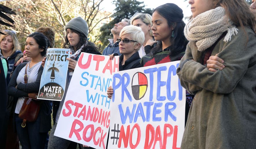 Protesters demonstrate in Salt Lake City in support of the Standing Rock Sioux against the Dakota Access Pipeline, Monday, Oct. 31, 2016. Following a rally at the Gallivan Center, the diverse group of over 100 marched half a block to the Wells Fargo Center building, where they held a protest in the lobby. Wells Fargo is one of several major banks financing the pipeline. (Al Hartmann/The Salt Lake Tribune via AP)