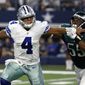 Dallas Cowboys quarterback Dak Prescott (4) fights off pressure from Philadelphia Eagles defensive end Brandon Graham (55) before throwing a pass in the first half of an NFL football game, Sunday, Oct. 30, 2016, in Arlington, Texas. (AP Photo/Michael Ainsworth)