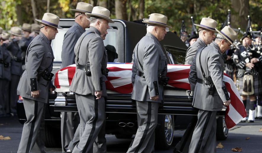 The casket of New York State Police Trooper Timothy Pratt is carried to St. Michael's Church on Monday, Oct. 31, 2016, in South Glens Falls, N.Y. Pratt died after being struck by a car while assisting a trucker who had stopped in a highway median in front of the trooper station in Wilton, where he worked. (AP Photo/Mike Groll)