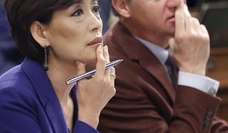 FILE - In this June 19, 2015, file photo, Republican Assembly members Young Kim, of Fullerton, and Brian Jones, of Santee, watch as the votes are posted for the revised budget plan up for consideration at the Capitol in Sacramento, Calif. Kim&#39;s campaign says someone stole 30 tablets and a laptop computer from her Orange County campaign office. (AP Photo/Rich Pedroncelli, File)