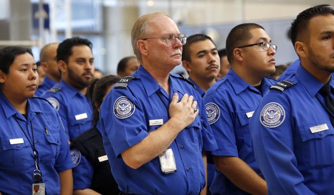Transportation Security Administration personnel take part in a formal ceremony of remembrance on the third anniversary of a shooting rampage that killed a TSA officer and wounded others at Los Angeles International Airport Tuesday, Nov. 1, 2016. Officers, travelers and others at the airport observed a moment of silence at 9:20 a.m. to honor TSA agent Officer Gerardo Hernandez, who was killed on Nov. 1, 2013. Paul Ciancia, 26, has pleaded guilty to murder and 10 other charges, and is scheduled to be sentenced to life in prison on Monday, Nov. 7. (AP Photo/Nick Ut)