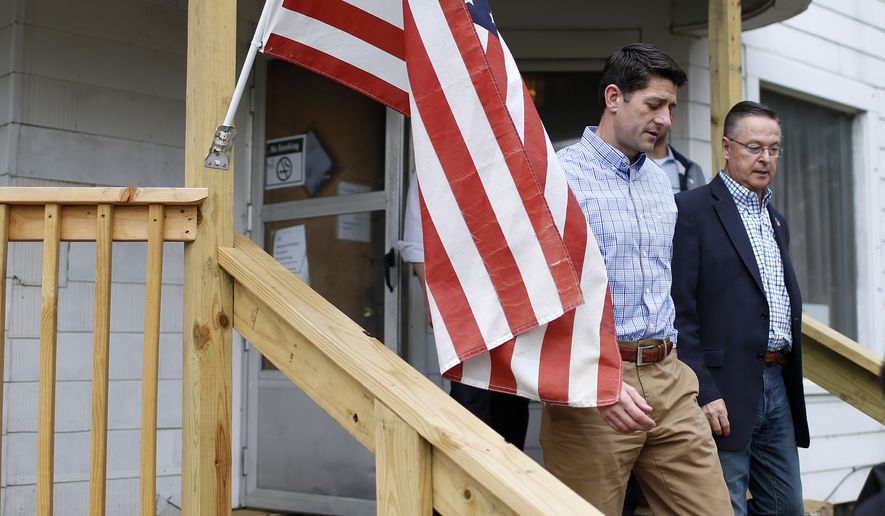 U.S. House Speaker Paul Ryan, left, and U.S. Rep. Rod Blum walks during a tour of a Catholic hospitality house Wednesday, Nov. 2, 2016, in Waterloo, Iowa. (Matthew Putney/The Courier via AP)