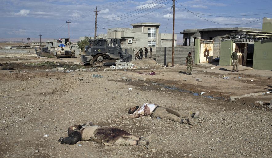 EDS NOTE: GRAPHIC CONTENT -- The bodies of two Islamic State militants lay on a street in Gogjali, an eastern district of Mosul, Iraq, Wednesday, Nov. 2, 2016. Iraqi special forces paused their advance in the eastern district of Mosul on Wednesday to clear a neighborhood of any remaining Islamic State militants, killing at least eight while carrying out house-to-house searches. (AP Photo/Marko Drobnjakovic)