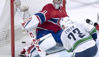 Vancouver Canucks defenseman Alexander Edler is stopped by Montreal Canadiens goalie Carey Price during the second period of an NHL hockey game Wednesday, Nov. 2, 2016, in Montreal. (Ryan Remiorz/The Canadian Press via AP)