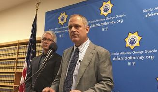 In this photo taken Tuesday, Nov. 1, 2016, San Francisco District Attorney George Gascon, left, and elections director John Arntz, right, discuss election security during a news conference in San Francisco. (AP Photo/Janie Har) ** FILE **