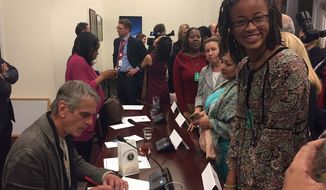 Kendall Clark, a sophomore at the Park School of Baltimore, gets an autograph from Oscar-winning actor Jeremy Irons at a White House panel on STEM (science, technology, engineering, mathematics) studies on Oct. 28. Kendall is one of the first students selected for the Spirit of Ramanujan Initiative, a global mentoring program for young mathematicians. Mr. Irons stars in a new film about Srinivasa Ramanujan, titled &quot;The Man Who Knew Infinity.&quot; Photo by Julia Porterfield / The Washington Times