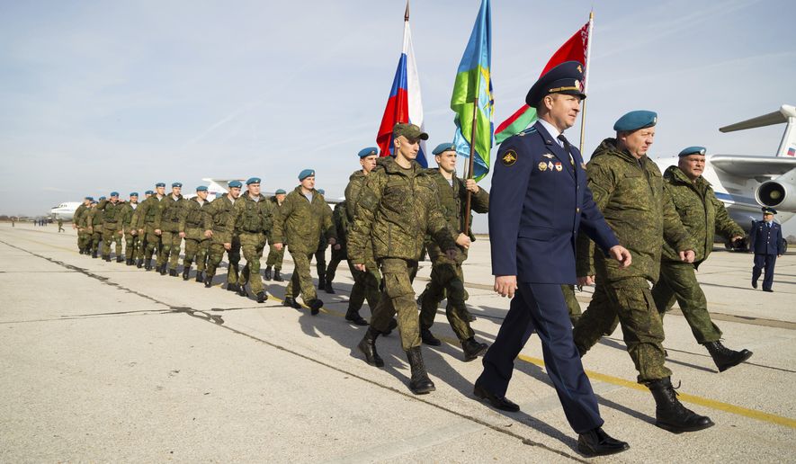 In this Wednesday, Nov. 2, 2016, handout photo released by Ministry of Defence Republic of Serbia, Russian soldiers march after arrival at the military airport Batajnica, near Belgrade, Serbia, Wednesday, Nov. 2, 2016. The six-day armed drills in Serbia, dubbed "The Slavic Brotherhood 2016," began Thursday. They involve 212 Russian troops, 3 transport planes, 450 soldiers from Serbia and 56 from Belarus. (Zarko Skoko/Ministry of Defence Republic of Serbia via AP)
