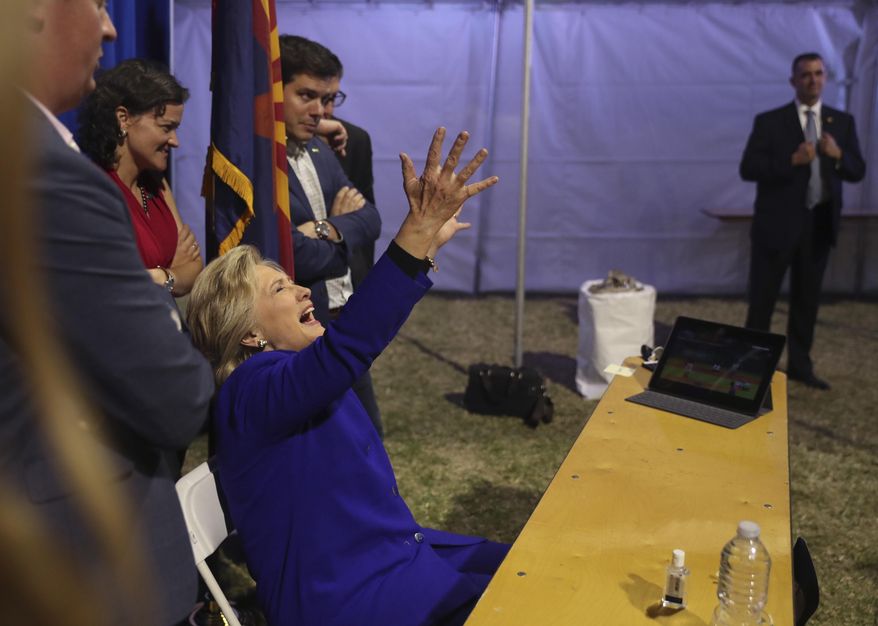 Democratic presidential candidate Hillary Clinton watches the World Series baseball game between the Chicago Cub and the Cleveland Indians after her final campaign rally of the day at Arizona State University in Tempe, Ariz., Wednesday, Nov. 2, 2016. (AP Photo/Andrew Harnik)