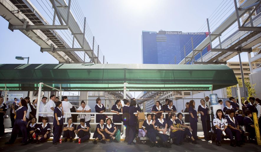 Paris hotel-casino employees wait outside of the establishment for updates of the power outage on Thursday, Nov. 3, 2016, in Las Vegas. (Elizabeth Page Brumley/Las Vegas Review-Journal via AP)