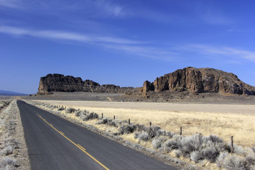ADVANCE FOR USE ON SUNDAY, NOV. 6, 2016, 12:01 A.M. AND THEREAFTER In this Sept. 20, 2016 photo, the Fort Rock State Natural Area is seen in the distance near Fort Rock, Ore. An enormous circle of jagged rock wall, Fort Rock provides an excellent level of natural protection. (Zach Urness/Statesman-Journal via AP)