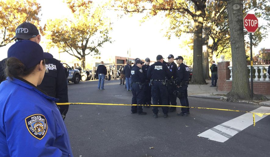 ADDS UPDATE OF ONE OFFICER FATALLY SHOT - New York City Police Officers gather at a shooting scene in the Bronx borough of New York, Friday, Nov. 4, 2016. say two New York City police sergeants were shot, one fatally, in a gun battle with a home invasion suspect. A police spokesman says the robbery suspect was killed in the gun fire exchange. (AP Photo/Julio Cortez)