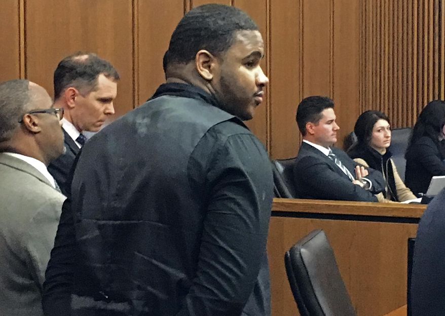 Douglas Shine Jr., front center, stands with attorneys as a verdict is read in his trial Friday, Nov. 4, 2016, at the Cuyahoga County Justice Center in Cleveland. Shine, accused of killing three people at a barbershop outside Cleveland, was found guilty on Friday of aggravated murder and other charges and could face the death penalty. (AP Photo/Mark Gillispie)