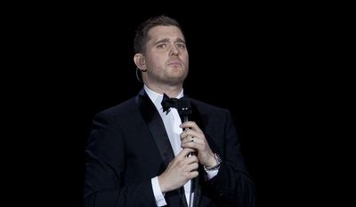 In this Jan. 31, 2014, file photo, Canadian singer Michael Buble performs during his concert at Palacio de los Deportes in Madrid, Spain. Buble announced on Nov. 4, 2016, that his 3-year-old son has been diagnosed with cancer and is undergoing treatment in the U.S. (AP Photo/Abraham Caro Marin, File)