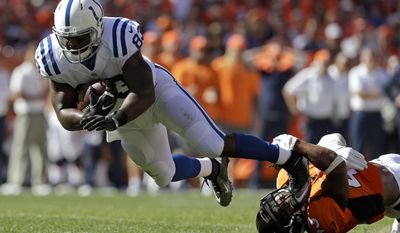 FILE - In this Sept. 18, 2016, file photo, Indianapolis Colts tight end Dwayne Allen, left, is tackled by Denver Broncos strong safety T.J. Ward during the first half in an NFL football game in Denver. Ward's 42 tackles at the halfway point are eight shy of his total from all of last season, when he made the Pro Bowl for the second straight year. (AP Photo/Joe Mahoney, File)
