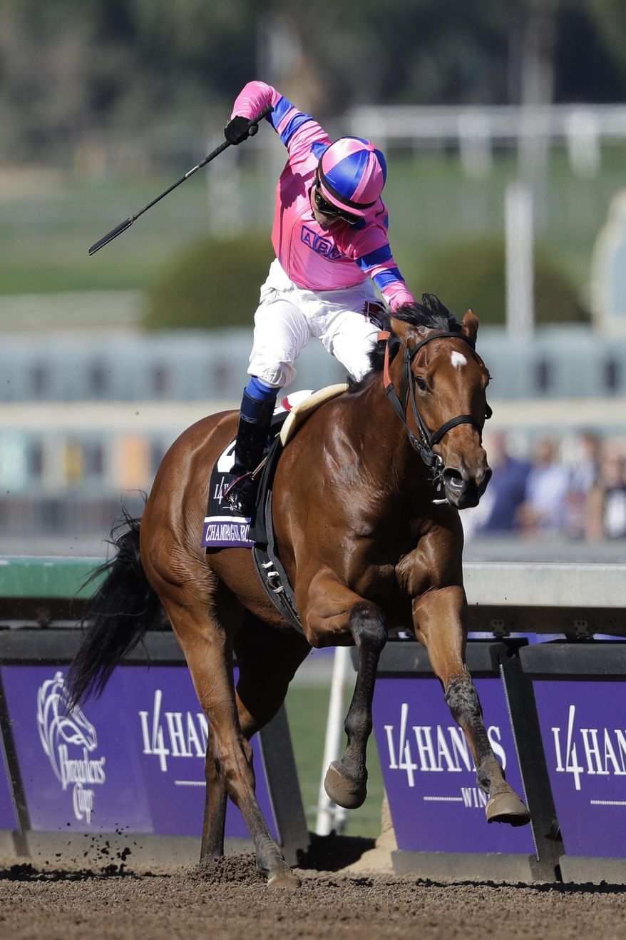 Jockey Mario Gutierrez celebrates after riding Champagne Room to victory in the Breeders' Cup Juvenile Fillies horse race at Santa Anita Park, Saturday, Nov. 5, 2016, in Arcadia, Calif. (AP Photo/Jae C. Hong)