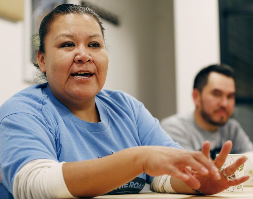 In this Wednesday, Oct. 26, 2016 photo, Juana Alvarez, 39, an undocumented Mexican housekeeper and immigrant rights community activist, talks about the upcoming presidential election at the Make the Road New York's Brooklyn offices in New York. Guatemalan immigrant Mauricio Pelaez-Alvarez, 33, (no relation), a day laborer and construction worker, listens, right rear. The estimated 11 million immigrants in the U.S. illegally are watching this potentially crucial election mostly from the sidelines. They can’t vote, so their future in this country depends on the choices other people make.(AP Photo/Kathy Willens)