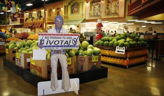 A sign in Spanish which translates, &quot;Don&#39;t Lose Your Voice, Vote!&quot; is displayed near a polling place in a Cardenas supermarket in Las Vegas on June 10, 2016. (Associated Press) **FILE**