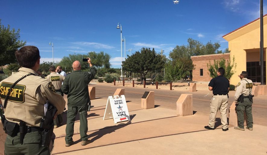 Pima County sheriff's deputies and officers from other law enforcement agencies view a demonstration of a drone Tuesday, Nov. 1, 2016 in Sahuarita, Ariz. The Sahuarita Police Department will be the first in the region to utilize aerial drones as an investigative tool. (Courtesy of James Lawrence via The AP)