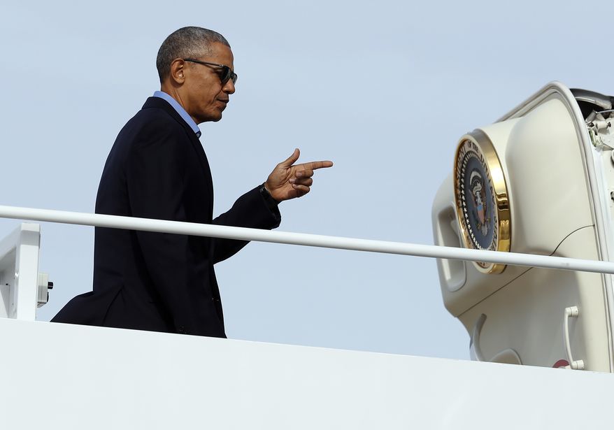 President Barack Obama points as he boards Air Force One in Andrews Air Force Base, Md., Sunday, Nov. 6, 2016, en route to Florida, where he will speak at a campaign event for Democratic presidential candidate Hillary Clinton at Osceola County Stadium. (AP Photo/Carolyn Kaster)