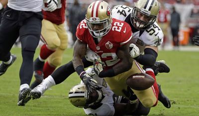 San Francisco 49ers running back Mike Davis (22) fumbles the ball near the goal line as New Orleans Saints inside linebacker Nate Stupar (54) and free safety Jairus Byrd, bottom, look on during the second half of an NFL football game Sunday, Nov. 6, 2016, in Santa Clara, Calif. (AP Photo/Tony Avelar)