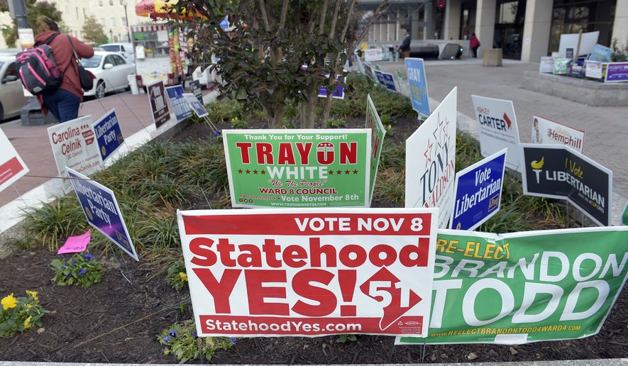In this photo taken Nov. 3, 2016, signs supporting DC statehood are on display outside an early voting place on in Washington. District of Columbia voters will decide whether they want the nation&#39;s capital to become its 51st state. The D.C. Council choices include former Mayor Vincent Gray, and Del. Eleanor Holmes Norton, D-D.C. seeks re-election.  (AP Photo/Susan Walsh)