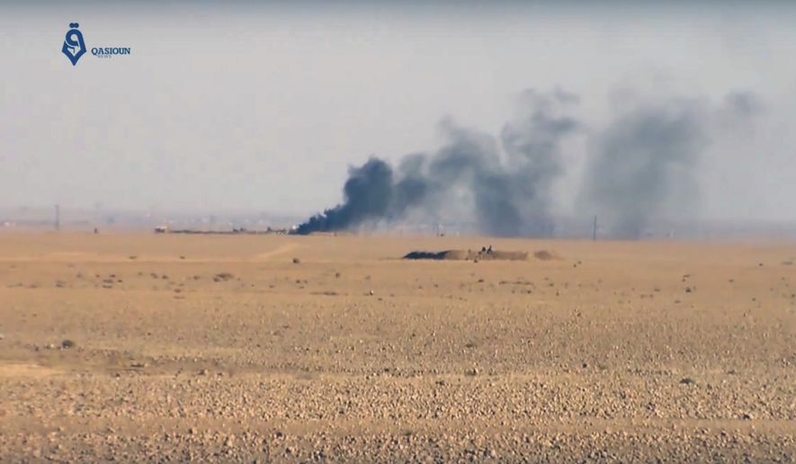 This frame grab from video provided by Qasioun a Syrian opposition media outlet, shows smoke rising as a result of clashes between U.S.-backed forces and the Islamic State group, near Ein Issa, north of Raqqa, Syria. Backed by U.S. airstrikes, Kurdish-led Syrian fighters clashed on Monday with Islamic State militants north of the city of Raqqa in Syria as they pushed ahead in their offensive aiming to liberate the city that has been the de facto capital of the extremist group since 2014. (Qasioun a Syrian Opposition Media Outlet, via AP)
